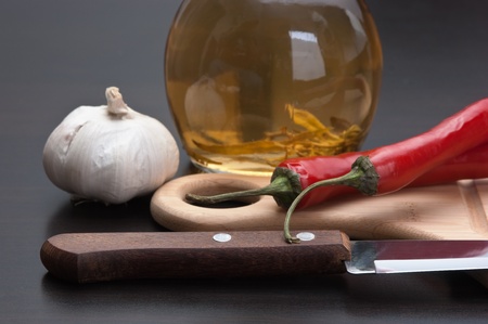 garlic and red chili peppers on the kitchen tableの写真素材