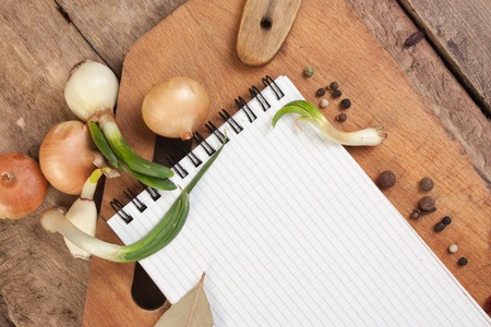 notebook for cooking recipes and spices on a wooden tableの写真素材