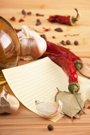 blank sheet for cooking recipes and spices on a wooden tableの写真素材