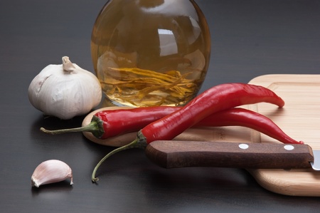 garlic and red chili peppers on the kitchen tableの写真素材
