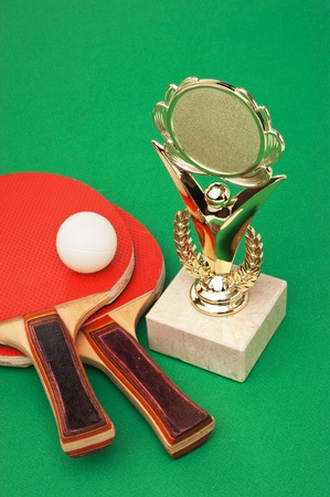 sports awards and  tennis racquets on a green tableの写真素材
