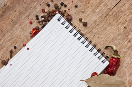 notebook for recipes and spices on an old wooden tableの写真素材