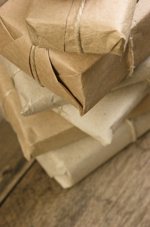 pile parcel wrapped with brown kraft paper and tied with twineの写真素材
