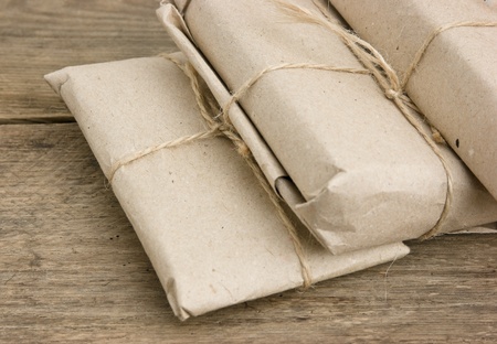 pile parcel wrapped with brown kraft paper and tied with twineの写真素材
