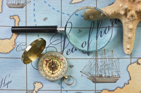 magnifier and compass on a stylized map