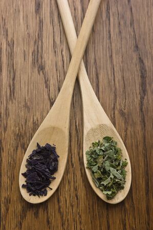 spices in wooden spoons on wooden tableの写真素材