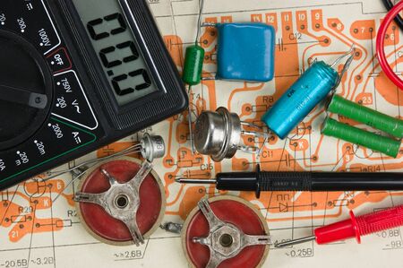 multimeter  and electronic components on circuit