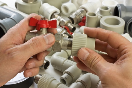 Set plumbing fittings in his handの写真素材