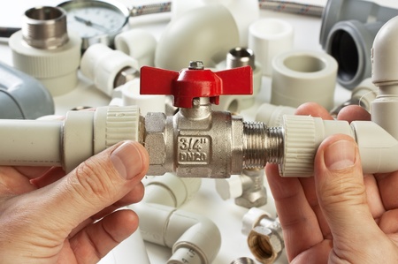 Set plumbing fittings in his handの写真素材