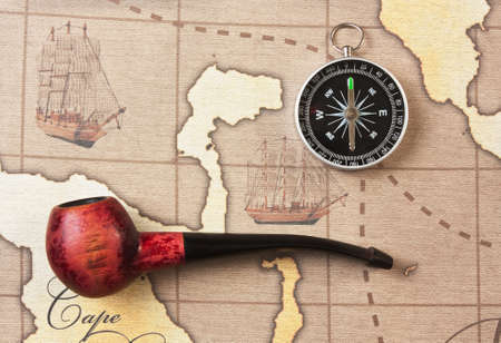 tobacco pipe and a compass on the mapのeditorial素材