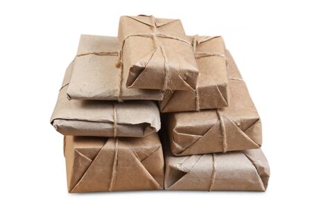 pile parcel wrapped with brown kraft paper isolatedの写真素材
