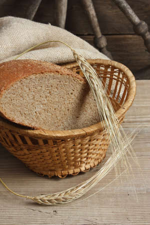 slices of rye bread and ears of corn on the wooden table