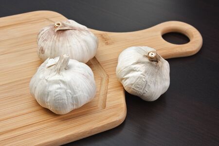 garlic on a kitchen cutting board