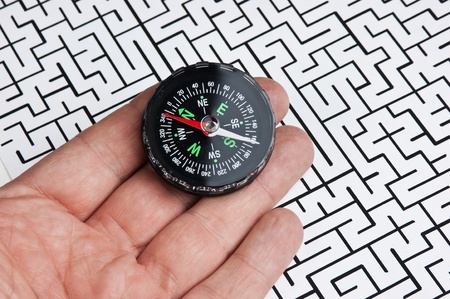 compass in hand on background of the labyrinthの写真素材