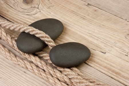 pebble and rope on a wooden backgroundの写真素材