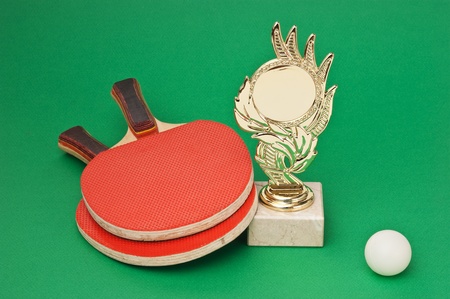 sports awards and  tennis racquets on a green tableの写真素材