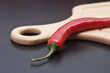 Red chili peppers on a cutting board