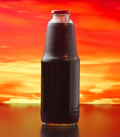 bottle of pomegranate juice at sunsetの写真素材