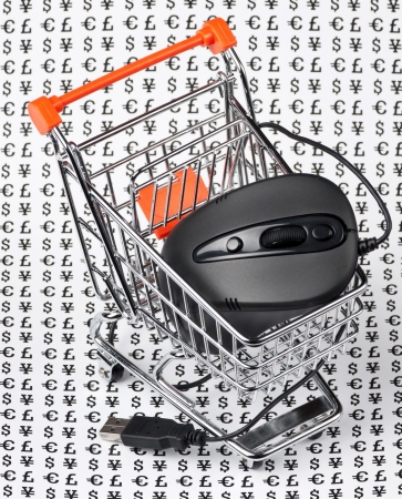 computer mouse  in a shopping trolley on a background of signs of moneyの写真素材