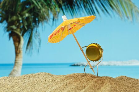 funny bottle cork on a sandy beachの写真素材