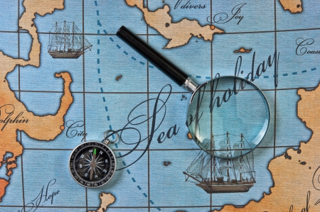 magnifier and compass on a stylized mapの写真素材