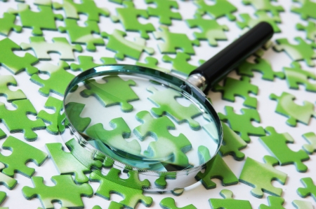 magnifying glass on the green puzzleの写真素材