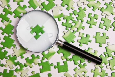 magnifying glass on the green puzzleの写真素材