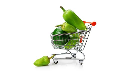 Green sweet pepper paprika  in shopping trolley isolated on white backgroundの写真素材