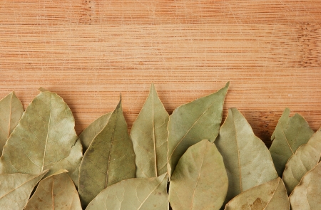dry bay leaf on a wooden kitchen cutting boardの写真素材