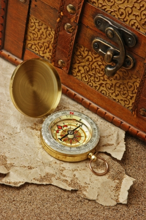 compass and old torn paper on a sandy beachの写真素材