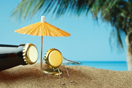 funny cork and bottle on a sandy beachの写真素材