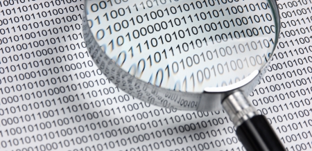 magnifying glass on the background of a binary codeの写真素材