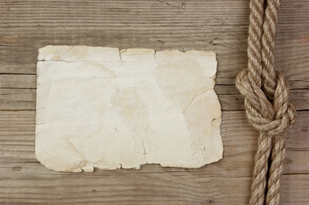 Vintage paper and rope on old wooden boardsの写真素材