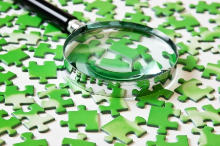 magnifying glass on the green puzzleの写真素材