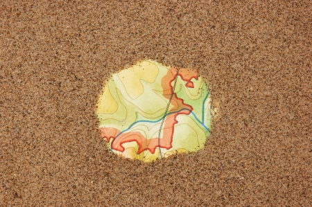 Vintage old map in the sandの写真素材