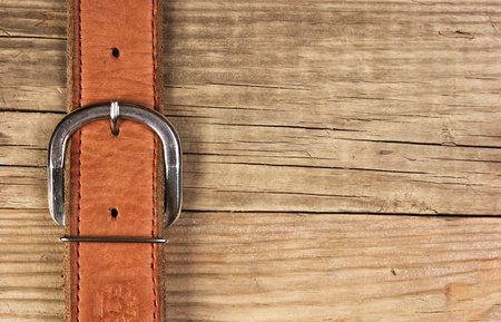 vintage belt buckle on a old wooden board