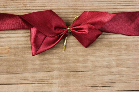 red bow and ribbon on the old wooden backgroundの写真素材