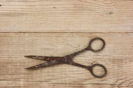 old rusty scissors on the wooden backgroundの写真素材