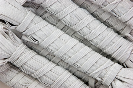 Sewing white rubber on a reelの写真素材