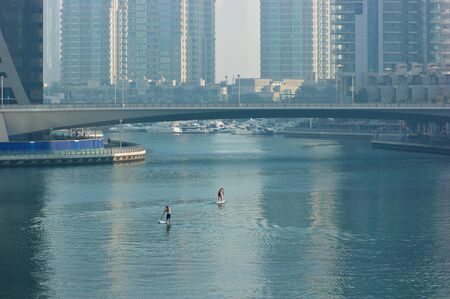 Two surfers on the city channel