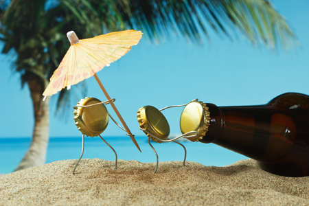 funny cork and bottle on a sandy beachの写真素材