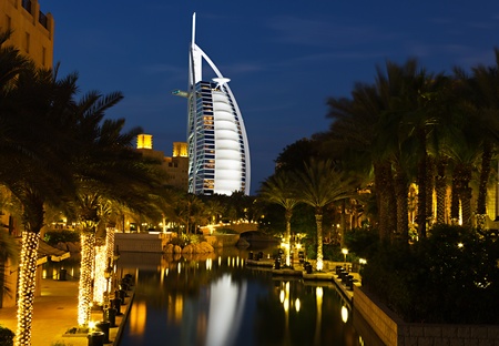 DUBAI, UAE-NOVEMBER 15: Night view of Burj al Arab hotel (7 star, 1999) from territory of Madinat Jumeirah hotel on November 15, 2012 in Dubai, UAE. Madinat Jumeirah - luxury 5 star hotelのeditorial素材