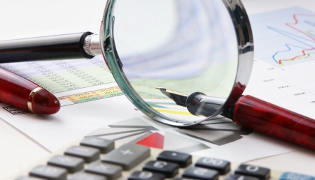 pen, magnifying glass and the working paper with a diagramの写真素材