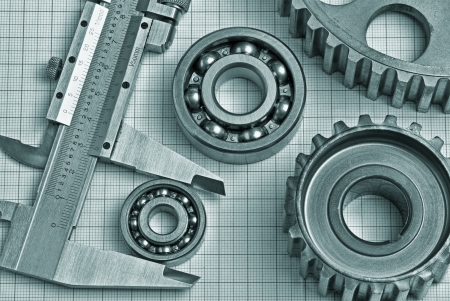 caliper with gears and bearings on graph paperの写真素材