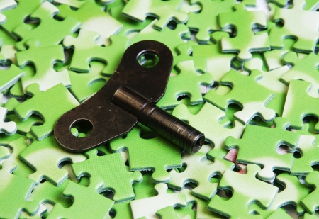key on pile of green puzzleの写真素材