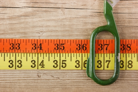 sartorial meter and scissors on the old wooden backgroundの写真素材