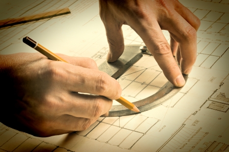 hand draws a pencil on the drawingの写真素材