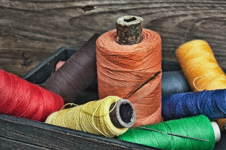 still life of spools of thread on a wooden backgroundの写真素材