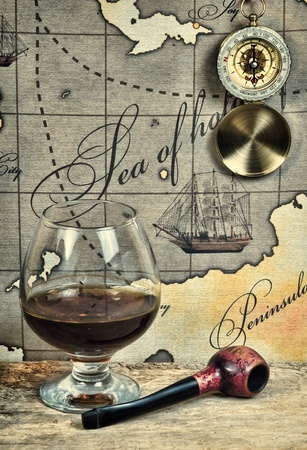 bottle and  glass of wine on background of old mapsの写真素材