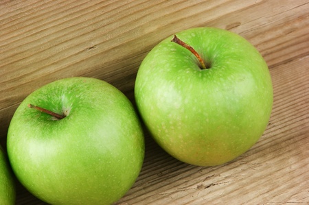 green apples on a wooden backgroundの写真素材